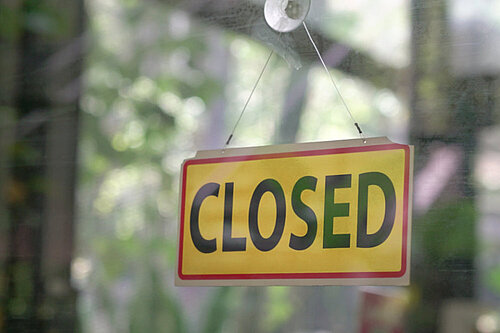 A sign reading closed in a window