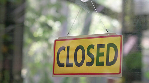 Closed Business A sign reading closed in a window