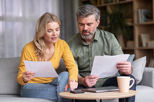 Stock image of a couple checking their bills