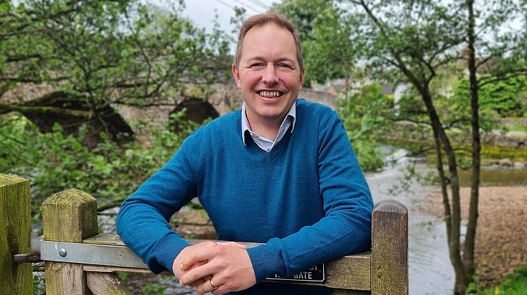 Richard Foord stood leaning on a country gate