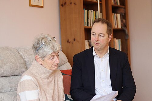 Richard Foord sat in a living room talking to a lady 