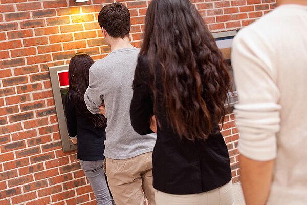 People queuing for an ATM.