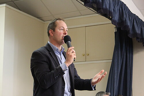 Richard Foord MP speaking at a public meeting in support of Seaton Community Hospital in Colyford Memorial Hall