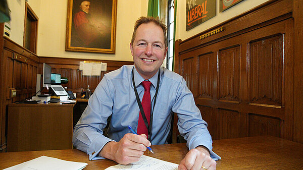 Richard Foord sat at a desk in Parliament