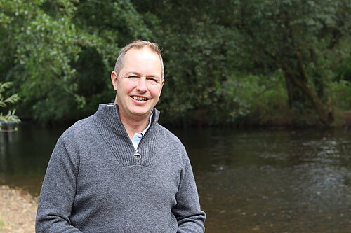 Richard Foord standing in front of a river