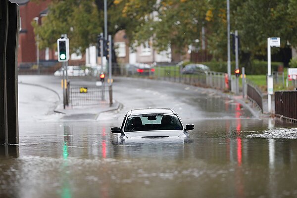 A car covered up with water after a flood.