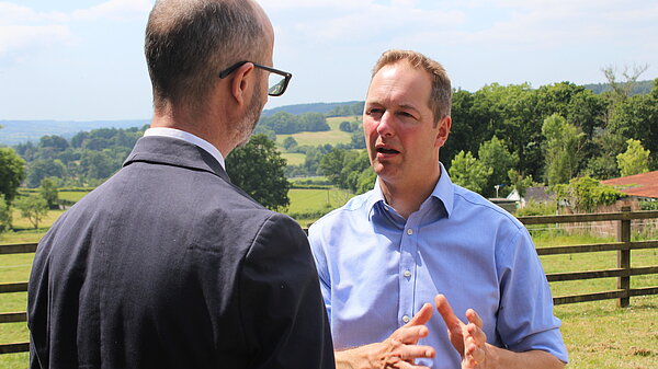 Richard Foord speaking to an interviewer in a field